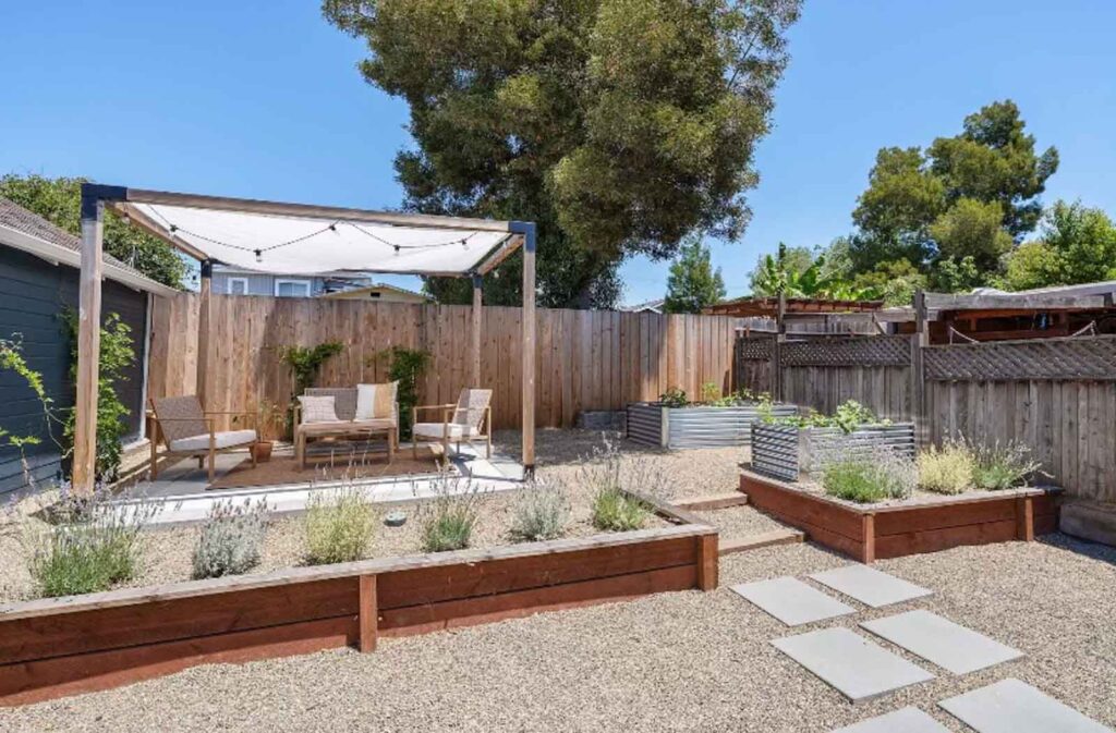 Agua Vista backyard remodel with covered patio and raised garden beds in Bend, OR