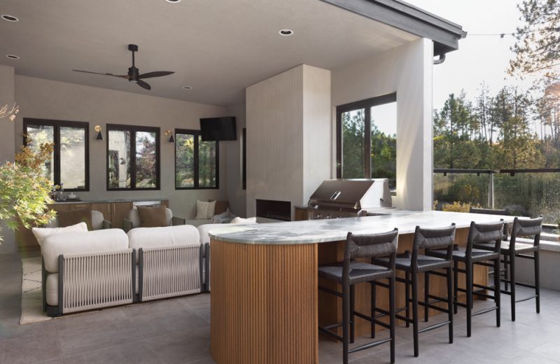 Magazine-featured outdoor living space with covered patio and bar
